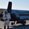 Military space plane lands after secret mission