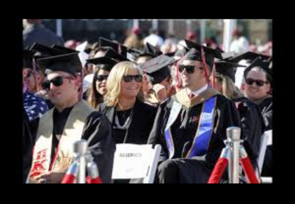 Mom who went to classes with quadriplegic son gets MBA